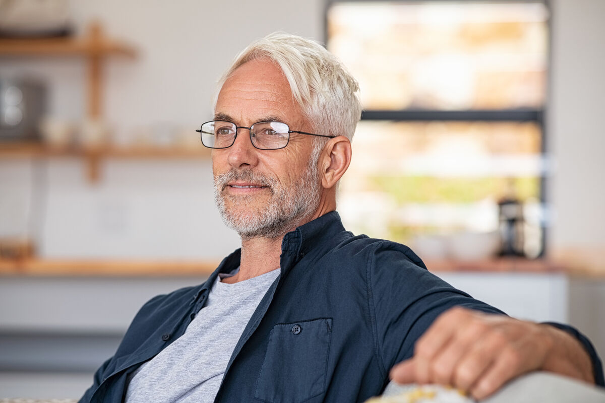 Man relaxing at home enjoying life feeling confident and well